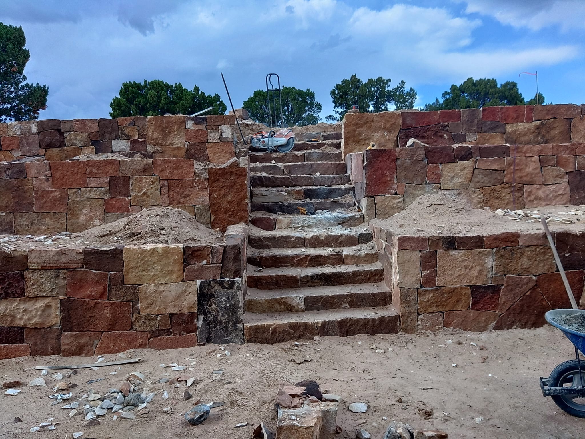 Large sandstone retaining wall with steps built by Ruano's